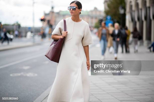 Katarina Petrovic wearing white dress during Stockholm Runway SS19 on August 30, 2018 in Stockholm, Sweden.