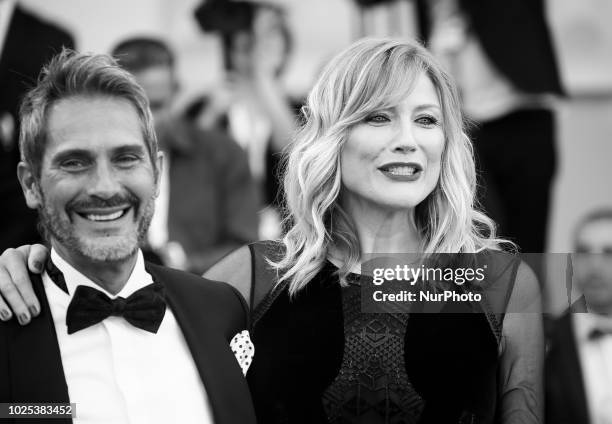 Image has been converted to black and white.) Natasha Stefanenko and Luca Sabbioni walks the red carpet ahead of the 'Roma' screening during the 75th...