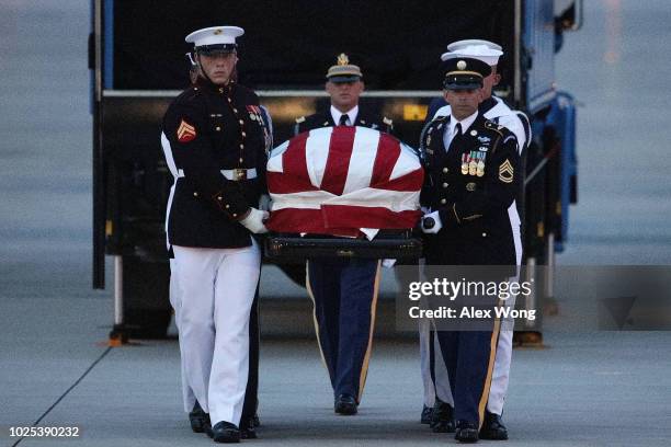 The flag-draped casket of U.S. Sen. John McCain is unloaded from an aircraft upon its arrival August 30, 2018 at Joint Base Andrews, Maryland. The...