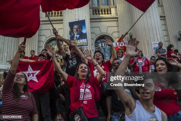 Demonstrators wave Workers' Party flags during a rally against local government officials and in support of jailed former president Luiz Inacio Lula...