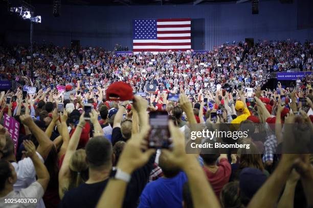 Attendees photograph U.S. President Donald Trump during a rally in Evansville, Indiana, U.S., on Thursday, Aug. 30, 2018. President Donald...