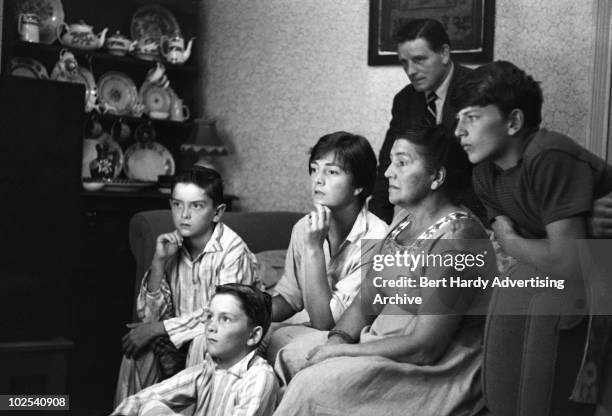 Family watching TV at their home in a village near Pontypridd, Wales, 22nd August 1959.