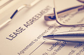 Business legal document concept : Pen and glasses on a lease agreement form. Lease agreement is a contract between a lessor and a lessee that allow lessee rights to use of a property owned by lessor