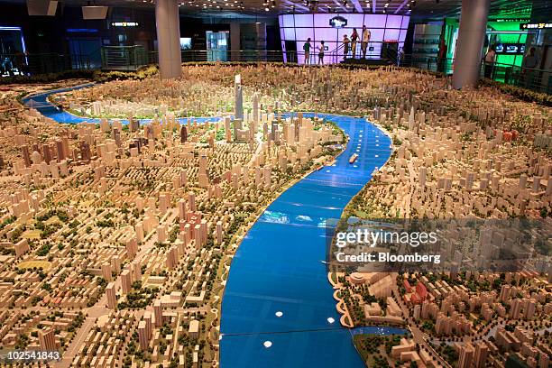 Visitor looks at models depicting the future development of Shanghai at the Shanghai Urban Planning Exhibition Center in Shanghai, China, on...