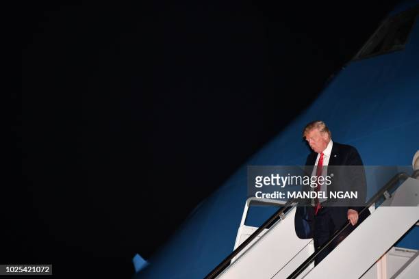 President Donald Trump steps off Air Force One upon arrival at Andrews Air Force Base in Maryland on August 30, 2018.