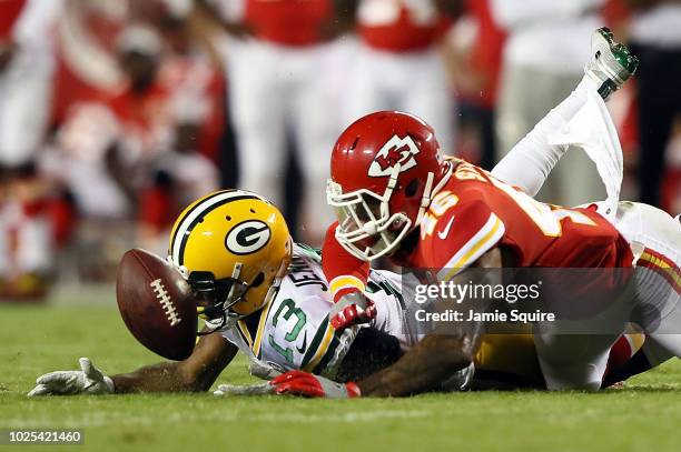 Defensive back Jordan Sterns of the Kansas City Chiefs breaks up a pass intended for wide receiver Adonis Jennings of the Green Bay Packers during...