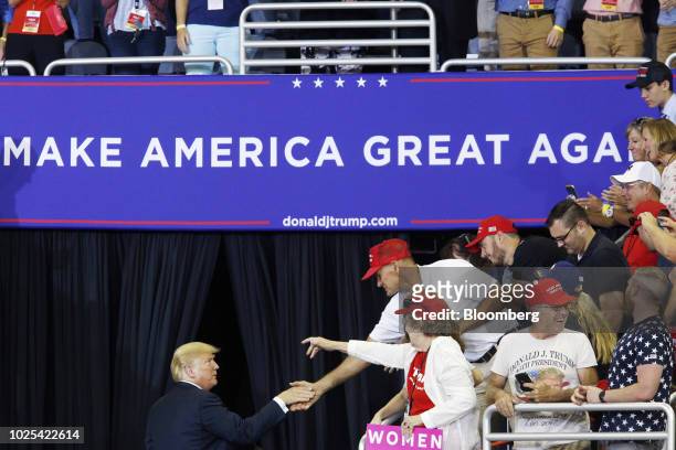 President Donald Trump shakes hands with supporters as he leaves a rally in Evansville, Indiana, U.S., on Thursday, Aug. 30, 2018. Trump wants to...