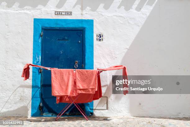clothes drying in front of whitewashed house - ibiza town stock pictures, royalty-free photos & images