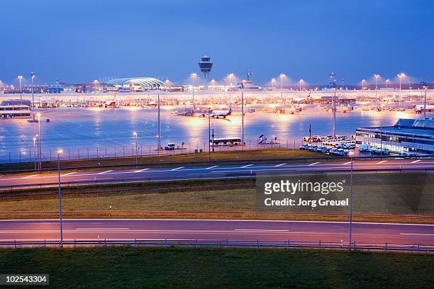 munich airport at dusk - munich airport stock pictures, royalty-free photos & images