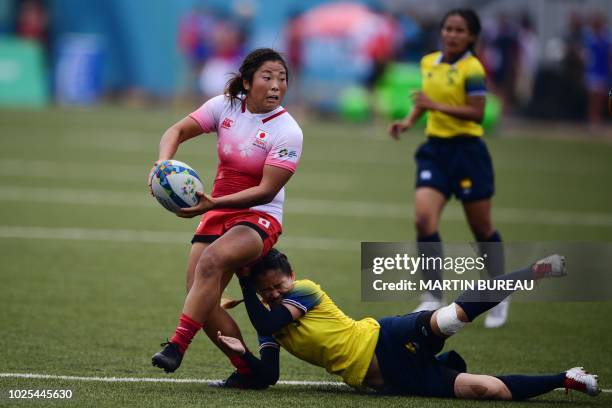 Japan's Yume Okuroda is tackled by Thailand's Rasamee Sisongkham during the women preliminary round group B rugby sevens match between Japan and...