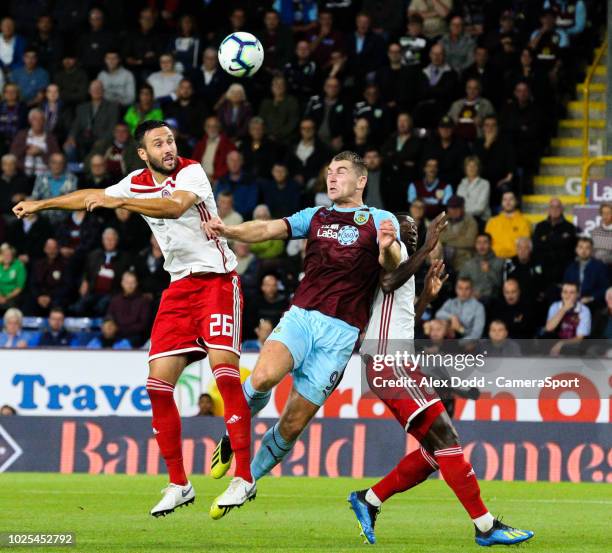 Burnley's Sam Vokes battles with Olympiakos' Jagos Vukovic and Mady Camara during the UEFA Europa League Qualifying Second Leg match between Burnley...