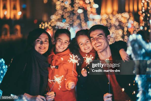 happy family celebrating new year - family new year's eve stock pictures, royalty-free photos & images