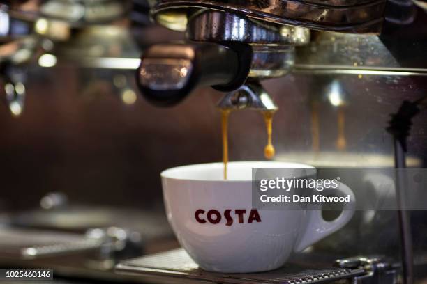 Latte is poured into a branded Costa Coffee mug at a Costa Costa coffee shop on August 31, 2018 in London, England. Coca-Cola Co. Is to buy the U.K....