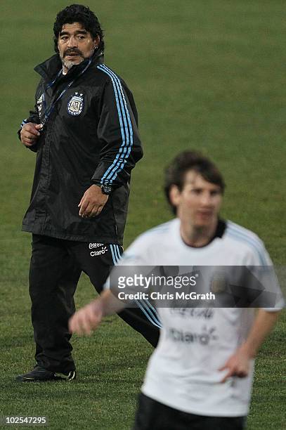 Argentina's head coach Diego Maradona watches on as Lionel Messi chases the ball during a team training session on June 30, 2010 in Pretoria, South...