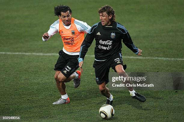 Gabriel Heinze of Argentina's national footbal keeps the ball away from Carlos Tevez during a team training session on June 30, 2010 in Pretoria,...