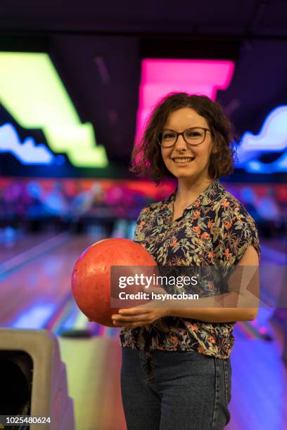 young woman playing bowling - bowling alley pins stock pictures, royalty-free photos & images