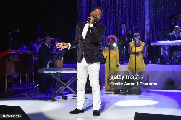 Singer Keith Washington performs on stage at a Tribute Concert to celebrate the life of songstress Aretha Franklin at Chene Park on August 30, 2018...