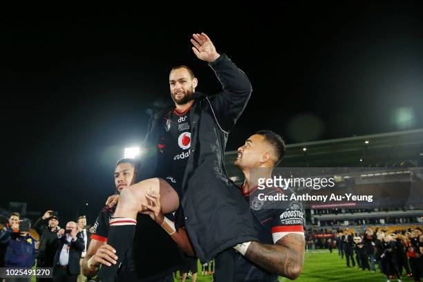 Simon Mannering of the Warriors is lifted up by his teammates as he comes off the field after winning in his 300th match and the round 25 NRL match...