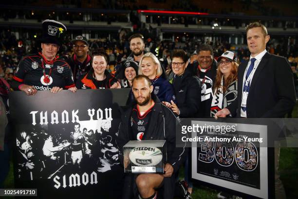 Simon Mannering of the Warriors poses for a photo with the match ball after winning in his 300th match and the round 25 NRL match between the New...