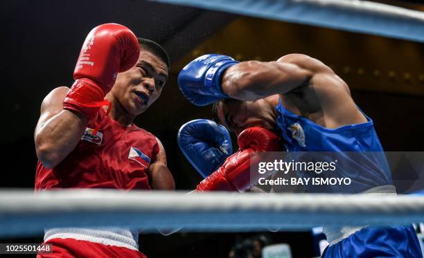 Philippines' Carlo Paalam fights against India's Amit in their men's light fly boxing semifinal at the 2018 Asian Games in Jakarta on August 31, 2018.