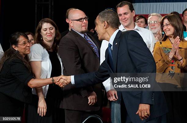 President Barack Obama greets guests during a town hall event on the economy at Racine Memorial Hall in Racine, Wisconsin, June 30, 2010. AFP PHOTO /...