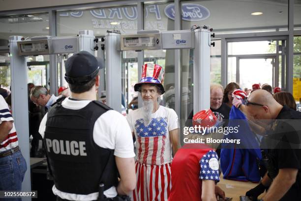 An attendee wearing an Uncle Sam costume passes through security inside a rally with U.S. President Donald Trump in Evansville, Indiana, U.S., on...