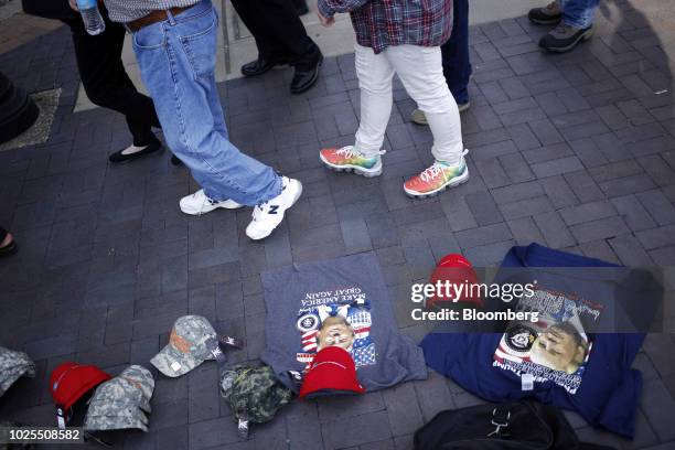 Vendor sells hats and shirts as attendees arrive for a rally with U.S. President Donald Trump in Evansville, Indiana, U.S., on Thursday, Aug. 30,...