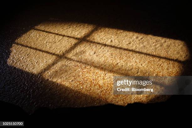 Sun shines on a vat of sour mash in a fermenter at the Brown-Forman Corp. Woodford Reserve bourbon distillery in Versailles, Kentucky, U.S., on...