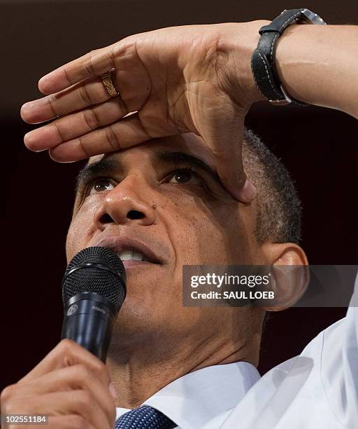 President Barack Obama looks for someone to ask a question during a town hall event on the economy at Racine Memorial Hall in Racine, Wisconsin, June...