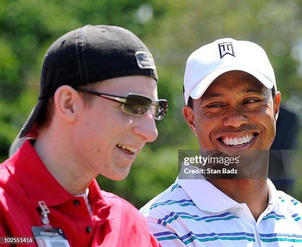 Wounded warrior, Brendan Marrocco, U.S. Army and Tiger Woods attend the opening ceremonies during the opening ceremonies for the AT&T National at...