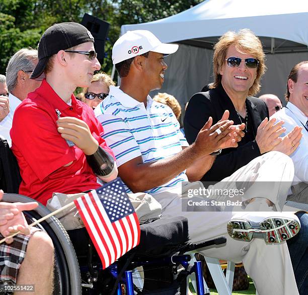 Wounded warrior, Brendan Marrocco of the U.S. Army, Tiger Wood and sing-songriter, Jon Bon Jovi, attend the opening ceremonies for the AT&T National...