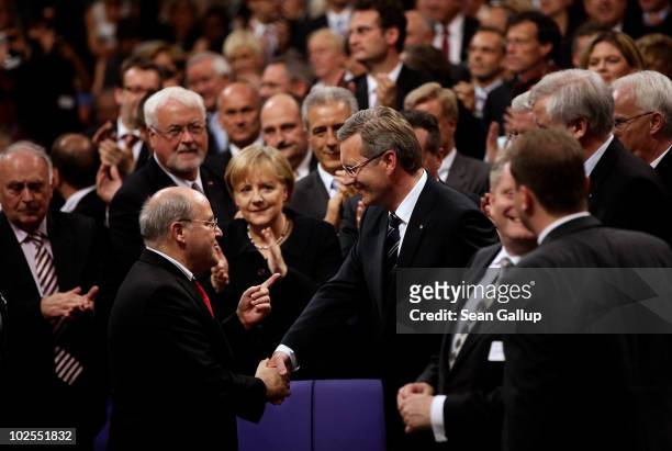 German presidential candidate Christian Wulff is congratulated by left-wing political party Die Linke Bundestag faction head Gregor Gysi as German...