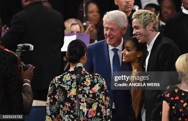Former US President Bill Clinton takes a picture with singer Ariana Grande and her fiancee Pete Davidson at Aretha Franklin's funeral at Greater...
