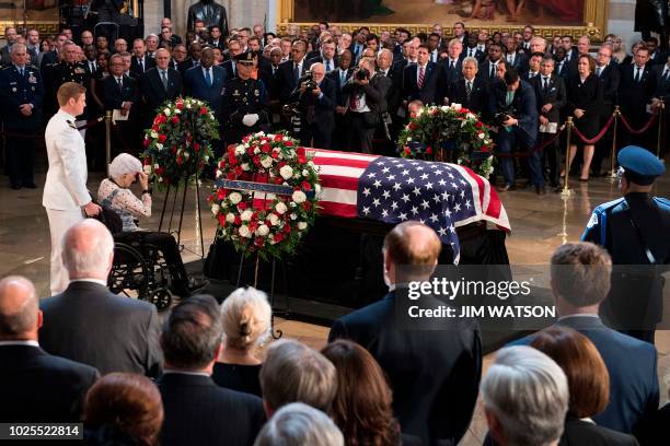 Roberta McCain , the 106-year-old mother of John McCain, pays her respects to the flag-draped casket bearing the remains of her son, who lived and...