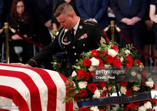 Jimmy McCain, son of late U.S. Senator John McCain, touches his father's casket during ceremonies honoring the late US Senator John McCain inside the...