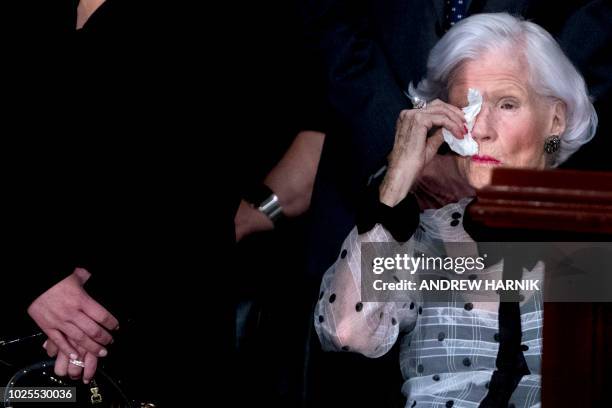 Roberta McCain, mother of US Senator John McCain, wipes her eyes as she looks at his casket as he lies in state in the Rotunda of the US Capitol on...