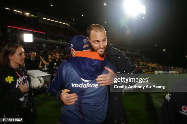 Simon Mannering of the Warriors is congratulated by Assistant Coach Andrew McFadden after winning in his 300th match and the round 25 NRL match...