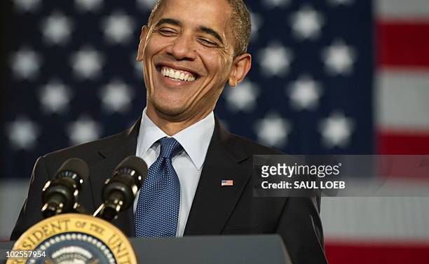 President Barack Obama laughs during a town hall event on the economy at Racine Memorial Hall in Racine, Wisconsin, June 30, 2010. AFP PHOTO / Saul...