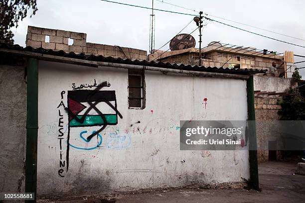 Palestinian man looks off his balcony in the Arab neighborhood where some hoses have been occupied by Jewish Israeli settlers on May 23, 2010 in east...