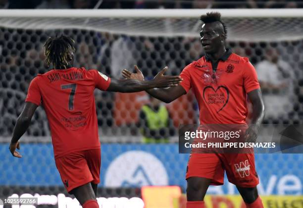 Nice's French midfielder Allan Saint-Maximin is congratulated by Nice's Italian forward Mario Balotelli during the French L1 football match between...