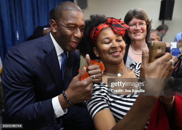 Andrew Gillum the Democratic candidate for Florida Governor poses for a picture with Cynthia Harris as he greets people during a campaign rally at...