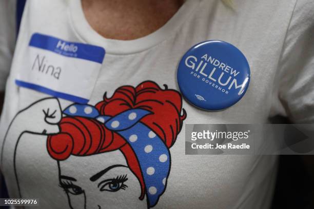 Supporter wears a campaign button in support of Andrew Gillum the Democratic candidate for Florida Governor as he speaks during a campaign rally at...