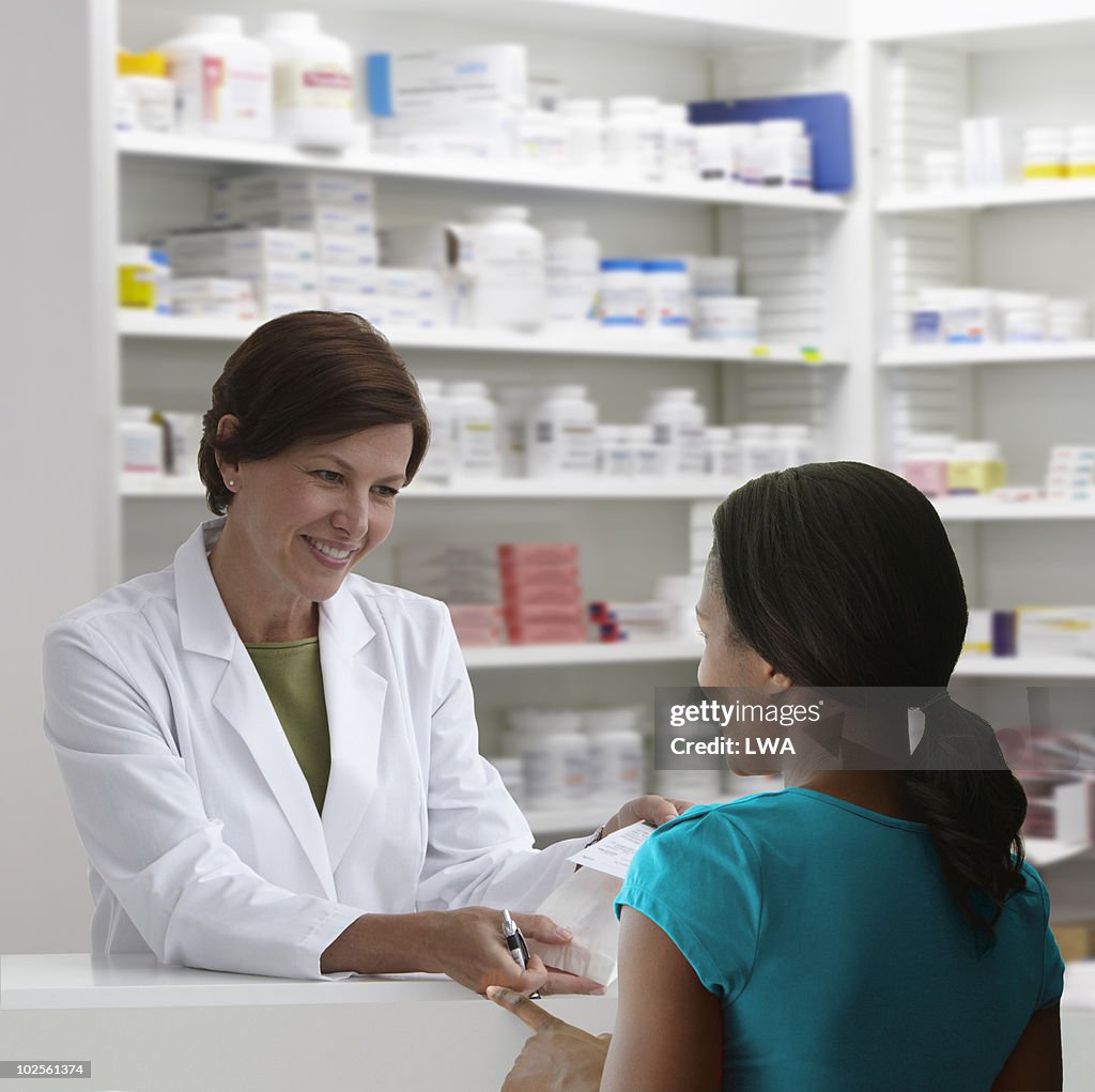 Pharmacist Explaining Medication To Customer