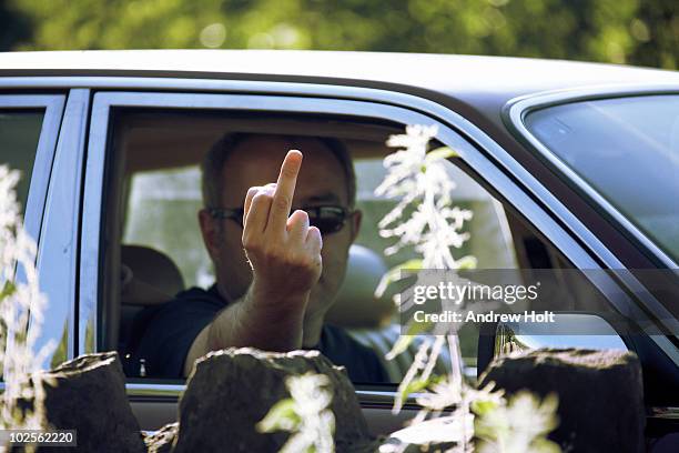 man in car making 'fuck off' sign - road rage stock pictures, royalty-free photos & images