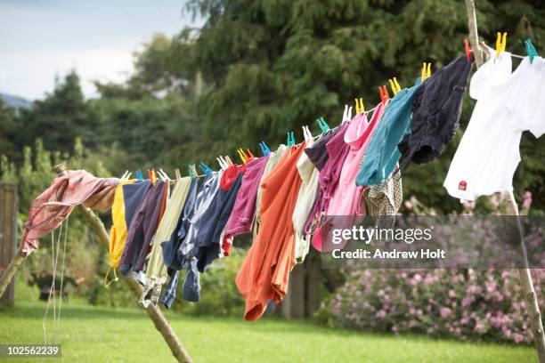 colourful washing on a clothes line - clothesline stock pictures, royalty-free photos & images