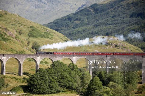 'jacobite' steam engine on glenfinnan viaduct - locomotive stock pictures, royalty-free photos & images