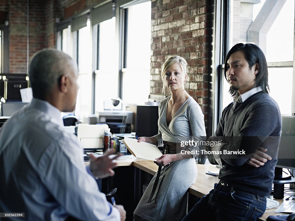 Group of coworkers in discussion in small office