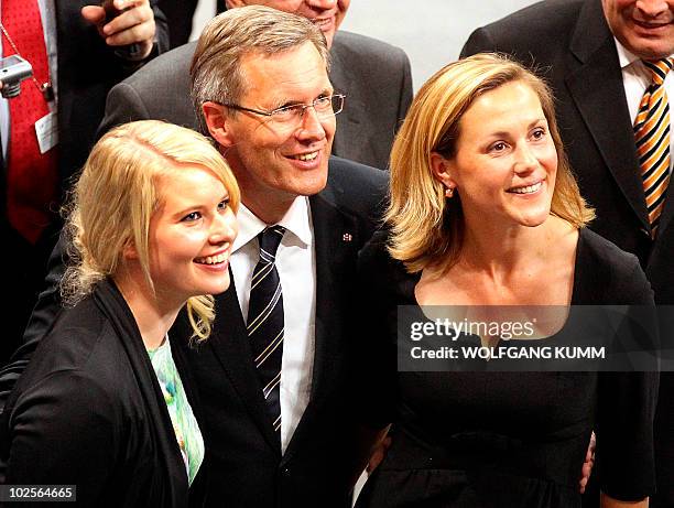 Lower Saxony's State Premier Christian Wulff, his wife Bettina Wulff and his daughter Annalena smile after after he was elected German President on...