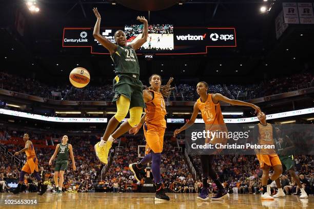 Jewell Loyd of the Seattle Storm looses the ball as she drives past Brittney Griner and DeWanna Bonner of the Phoenix Mercury during game three of...