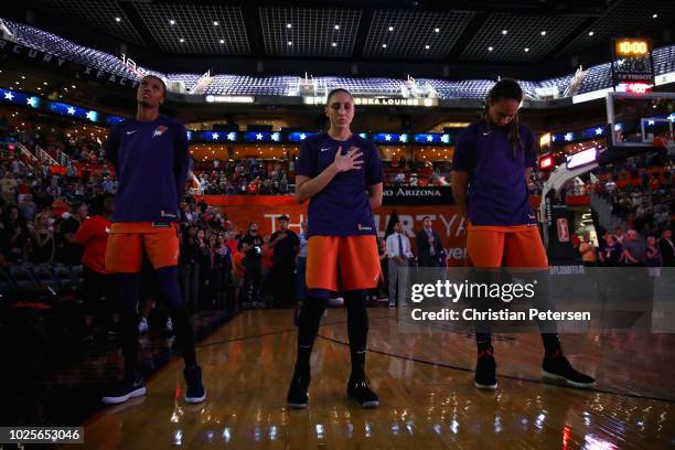 DeWanna Bonner, Diana Taurasi and Brittney Griner of the Phoenix Mercury stand attended for the national anthem before game three of the WNBA Western...